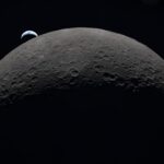 Earth rising over the moon's horizon