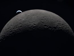 Earth rising over the moon's horizon