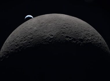 Earth rising over the moon's horizon