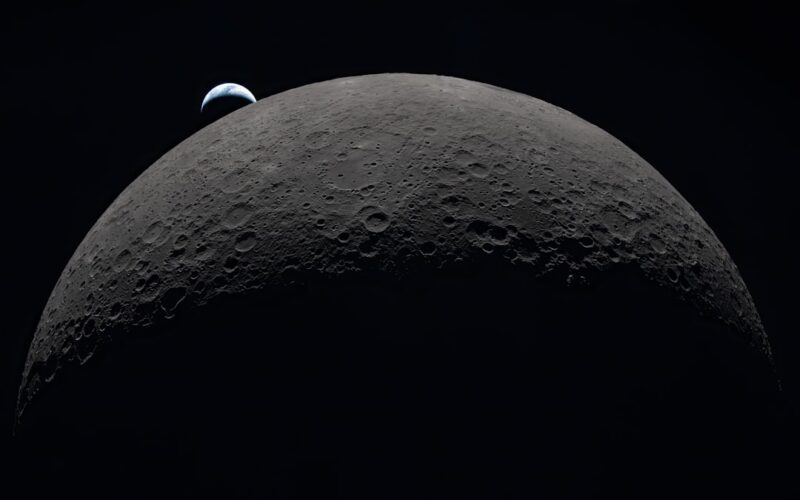 Earth rising over the moon's horizon