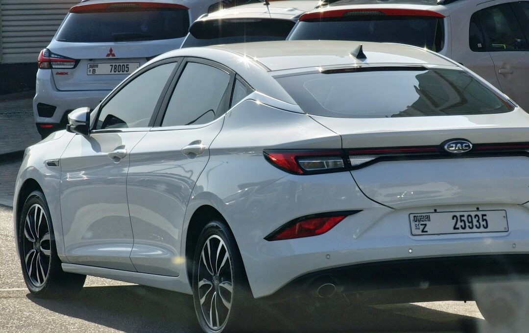 a white car parked in a lot next to other cars