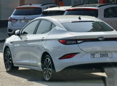 a white car parked in a lot next to other cars