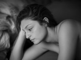 topless woman lying on bed