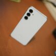 White smartphone with three cameras on desk