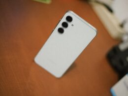 White smartphone with three cameras on desk