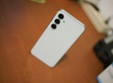White smartphone with three cameras on desk