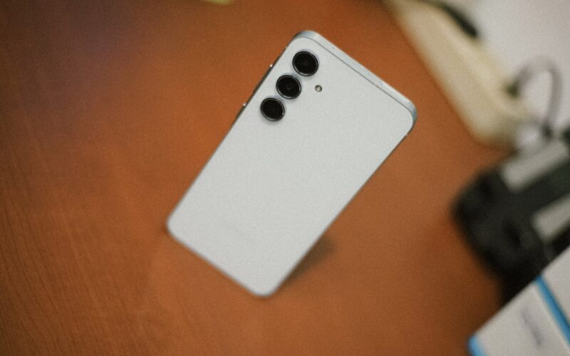 White smartphone with three cameras on desk