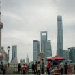 People gather near oriental pearl tower and skyscrapers