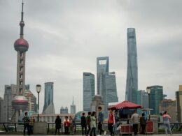 People gather near oriental pearl tower and skyscrapers