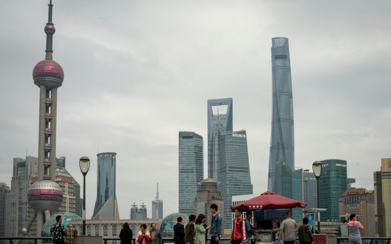 People gather near oriental pearl tower and skyscrapers