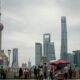 People gather near oriental pearl tower and skyscrapers