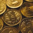 round gold-colored coin lot close-up photography