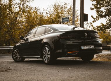 black porsche 911 parked near trees during daytime