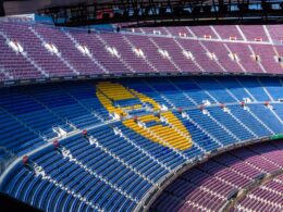 a sports arena with a field and seating