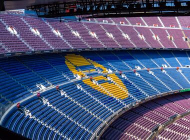 a sports arena with a field and seating