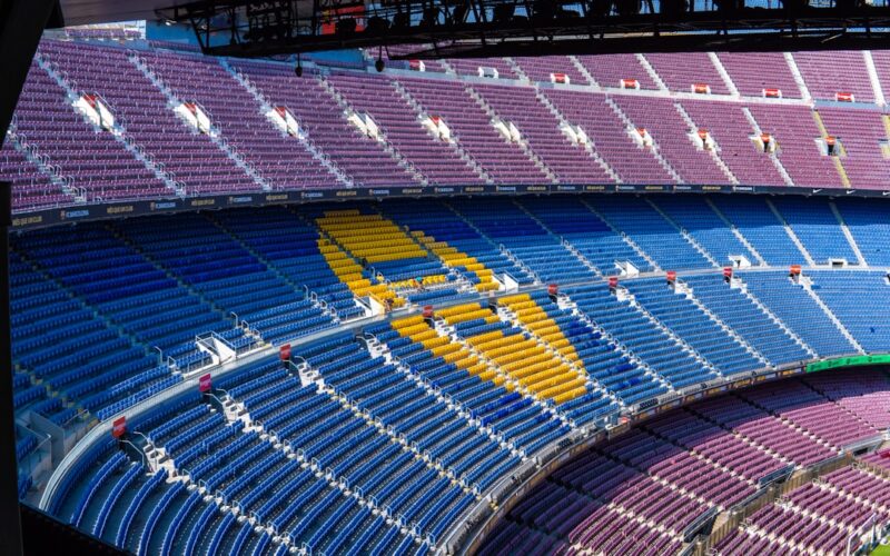 a sports arena with a field and seating