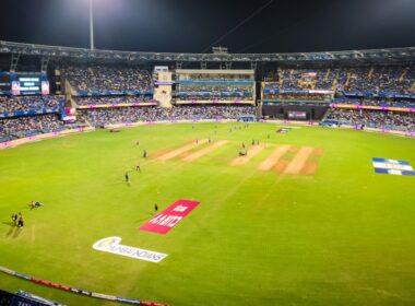 A cricket match is in progress at a stadium