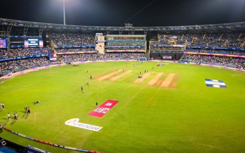 A cricket match is in progress at a stadium