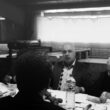 grayscale photo of men eating