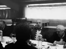 grayscale photo of men eating