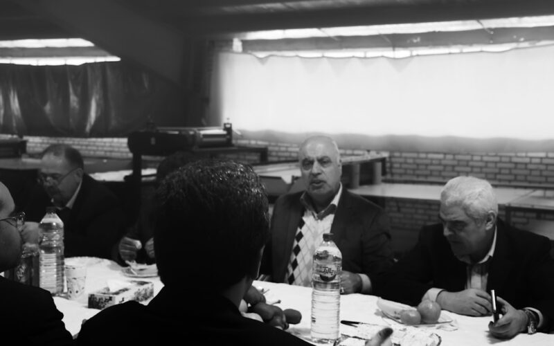 grayscale photo of men eating