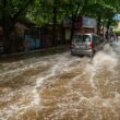 a car is driving through a flooded street