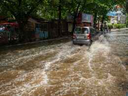 a car is driving through a flooded street