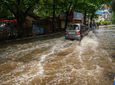 a car is driving through a flooded street