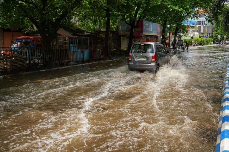 a car is driving through a flooded street