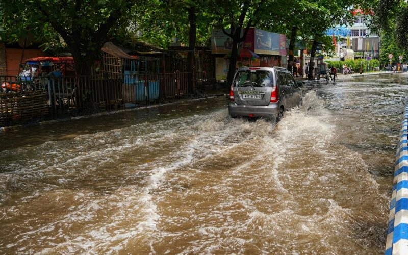 a car is driving through a flooded street