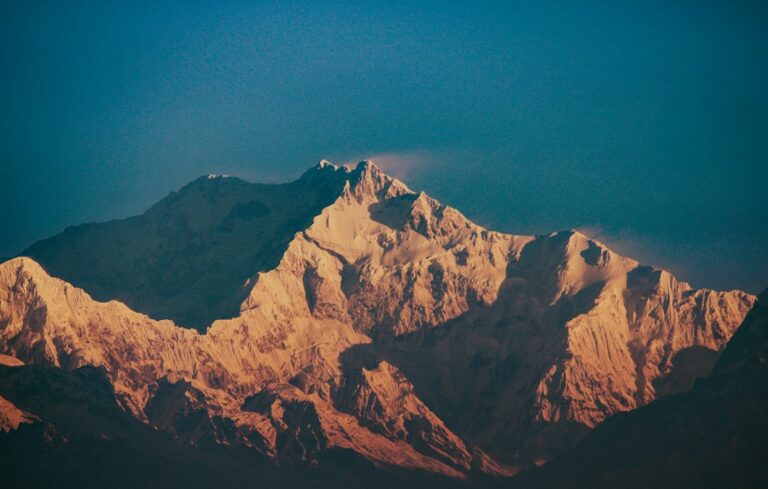 Jagged mountain peaks illuminated by golden sunlight