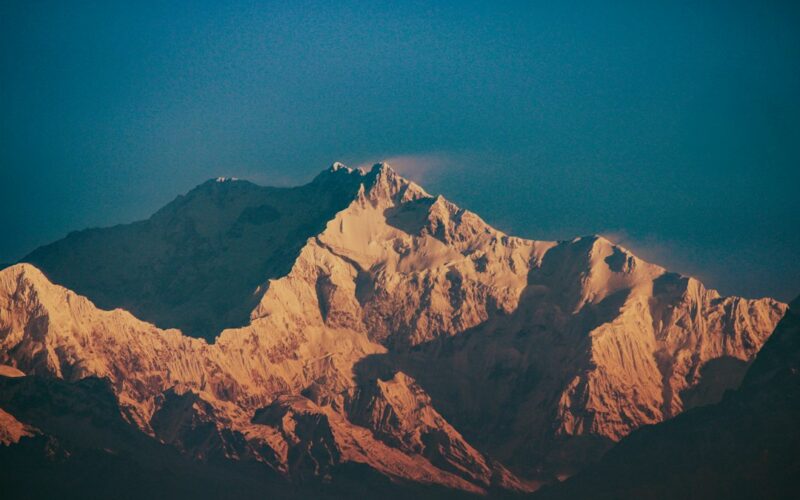 Jagged mountain peaks illuminated by golden sunlight