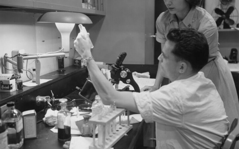 Two people working in a laboratory with equipment