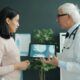 Doctor shows patient medical scan on tablet