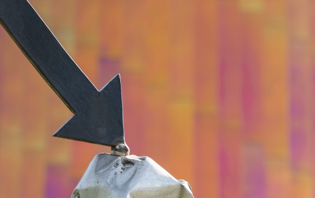a close up of a metal object with an arrow on it