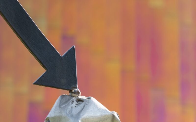 a close up of a metal object with an arrow on it