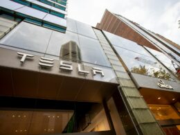 a tall building with a tesla sign on it's side