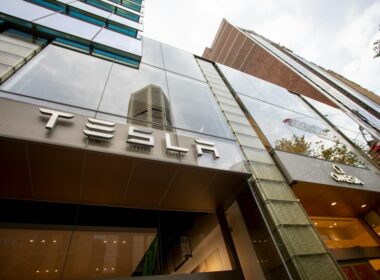 a tall building with a tesla sign on it's side