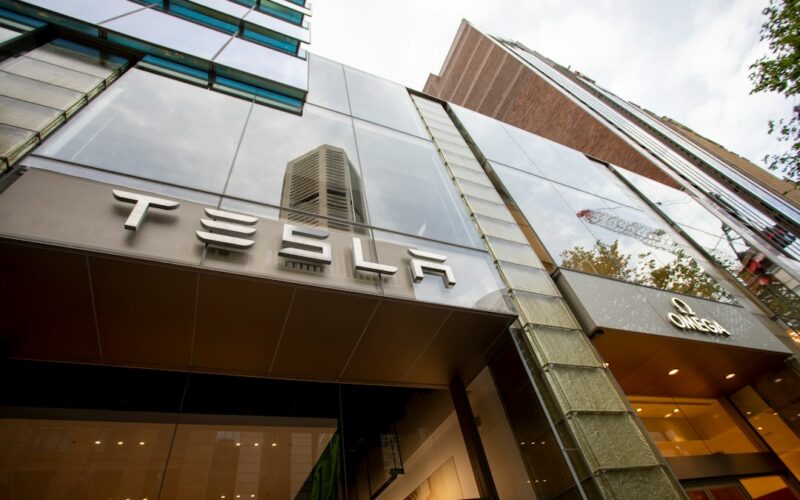 a tall building with a tesla sign on it's side