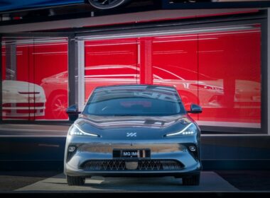A sleek car is parked in front of a showroom