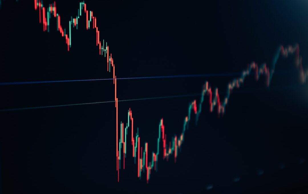 candlestick stock chart on dark screen