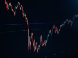 candlestick stock chart on dark screen